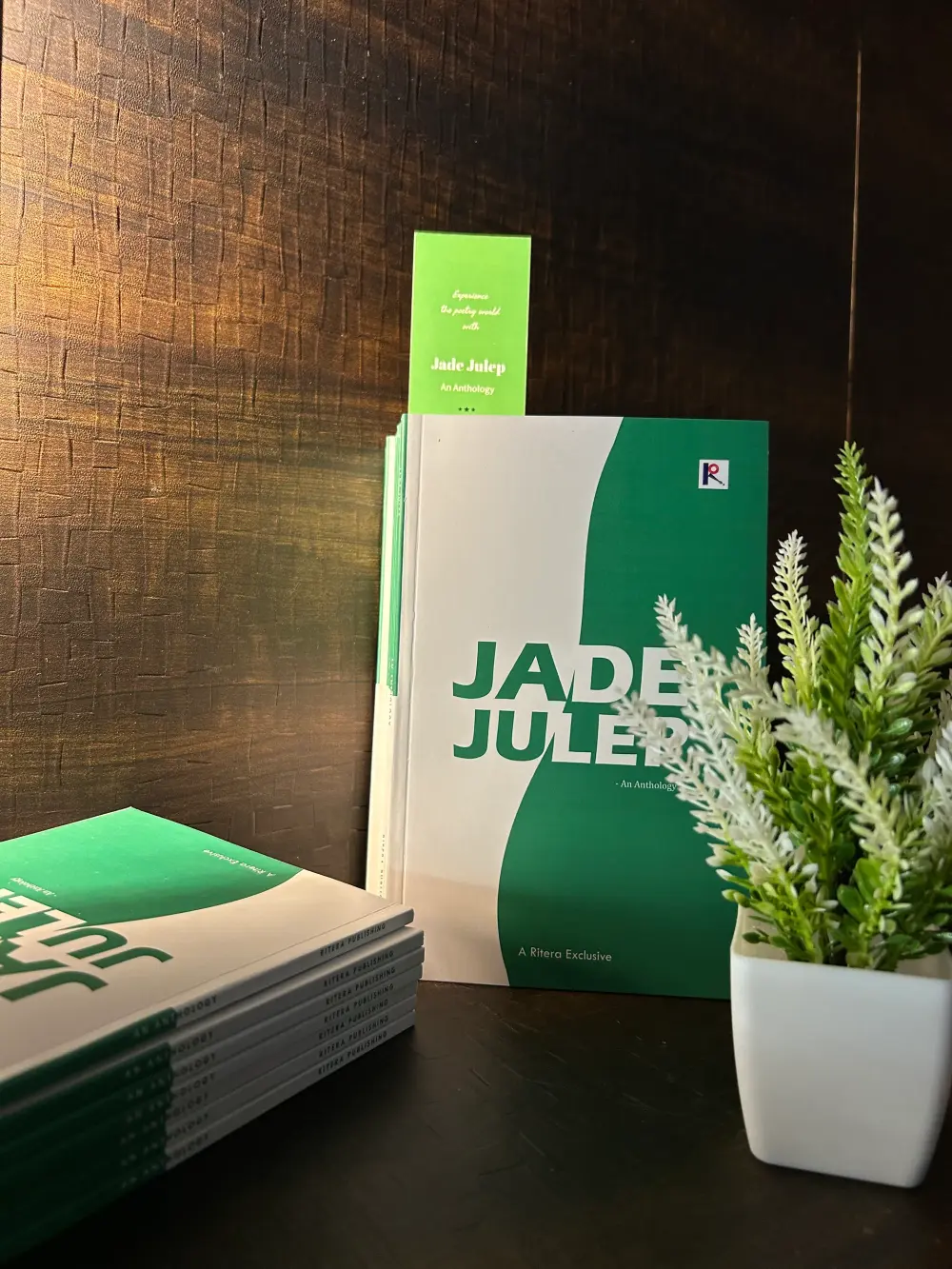 The published book Jade Julep — An Anthology, a Ritera Exclusive, displayed with a stack of printed copies