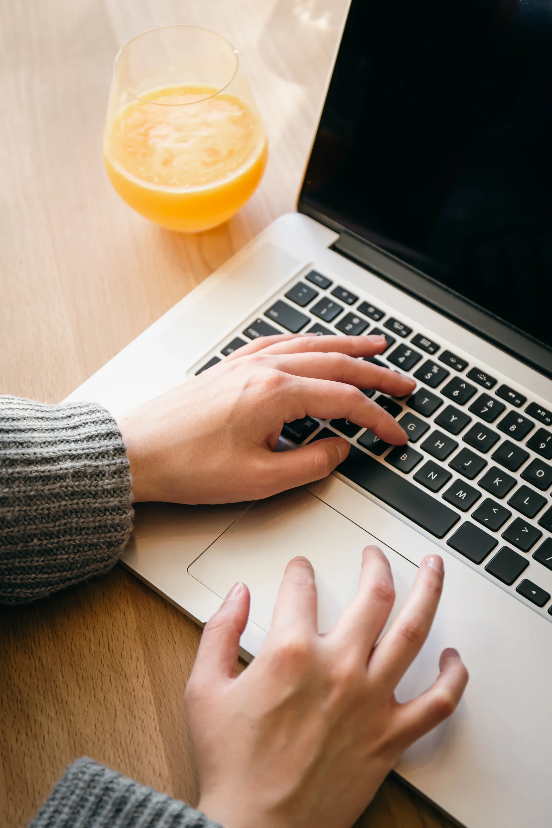 Writing on a laptop beside a cup of tea